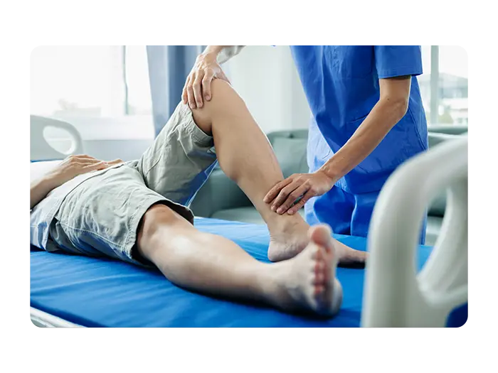 Doctor treating leg patient