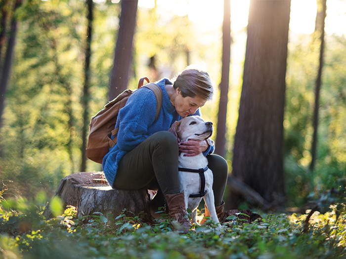 Woman outside sitting with her dog 