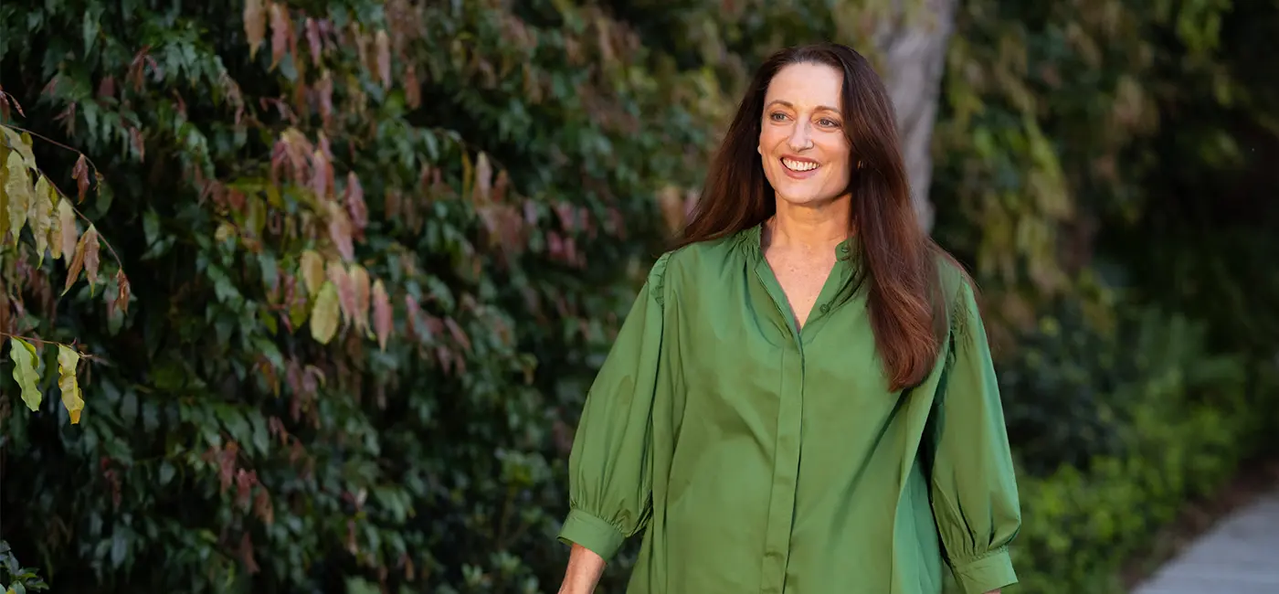 Image of Georgie outside walking towards the camera smiling