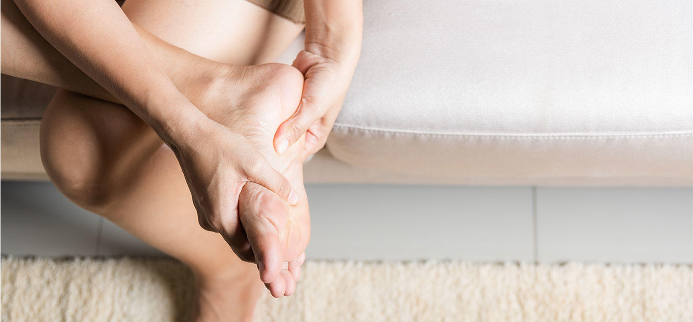 Image of woman rubbing the sole of her foot