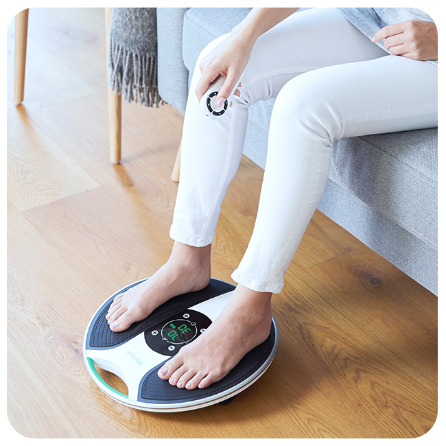 Woman with her feet on a medic device 