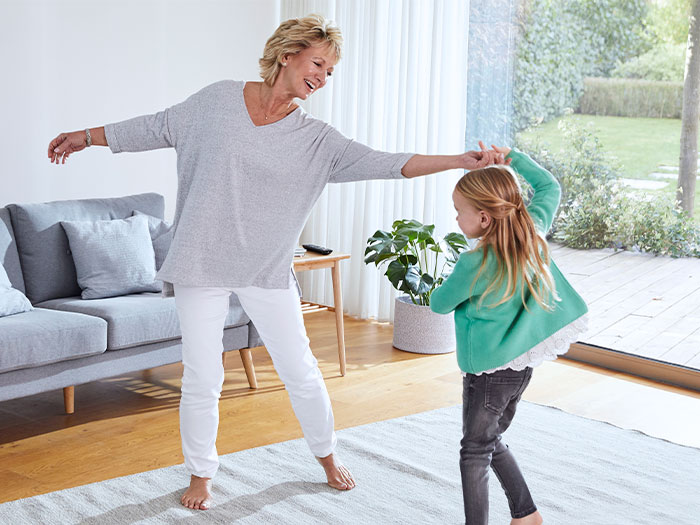Woman dancing with her granddaughter