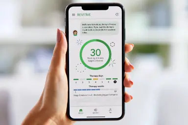 Person holding a phone open on the Revitive app