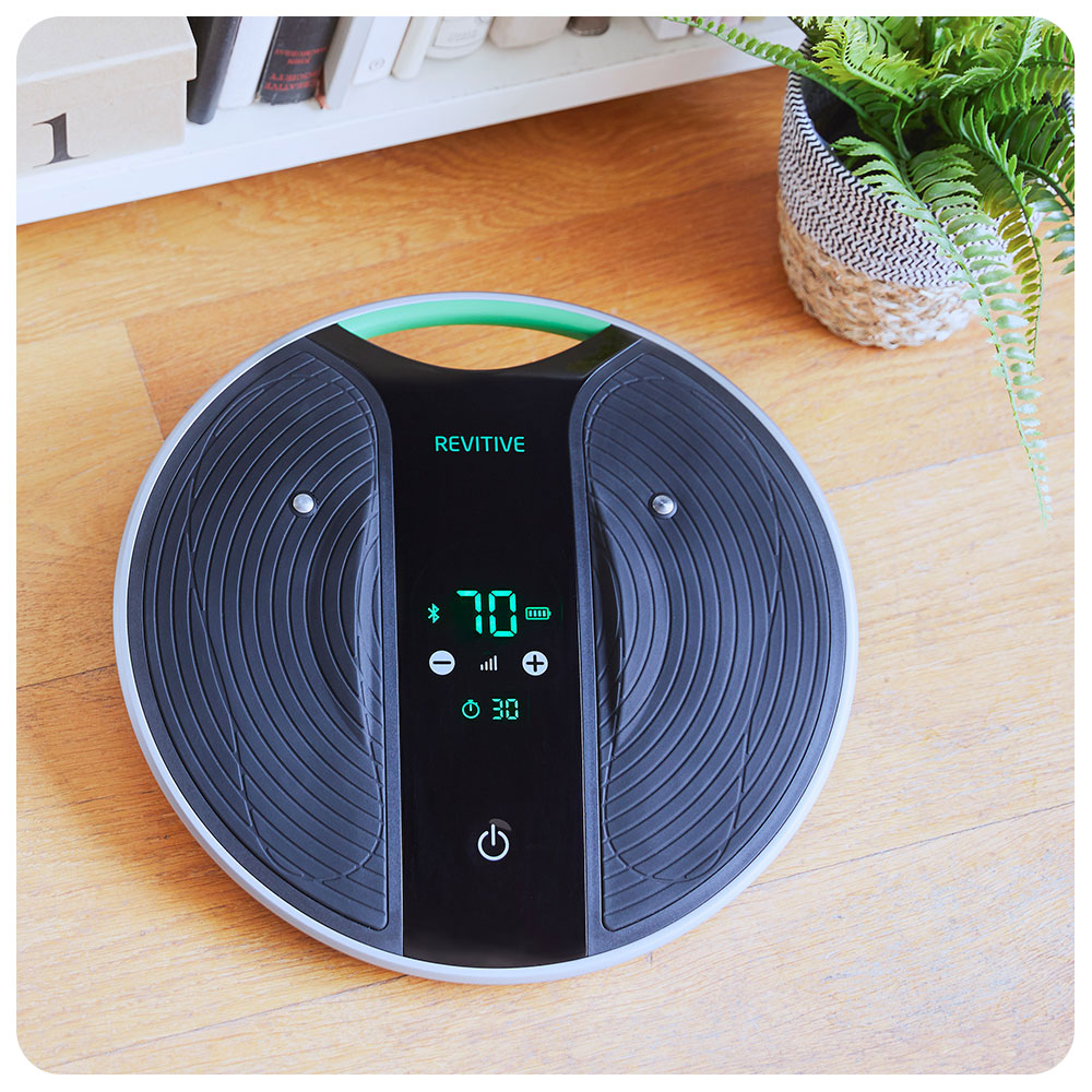 Medic Coach device sat on the floor next to a bookshelf 