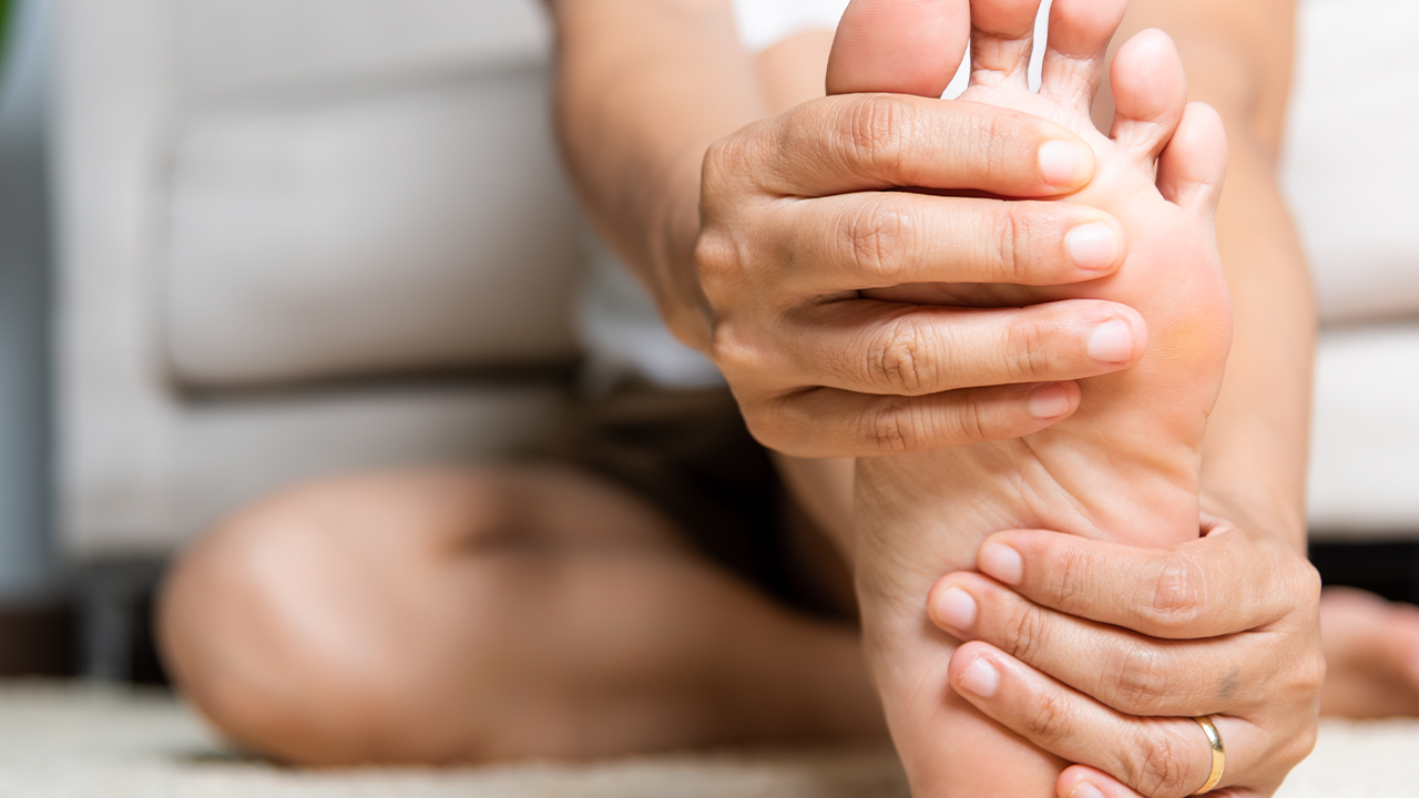 Close up image of a person holding the bottom of their foot