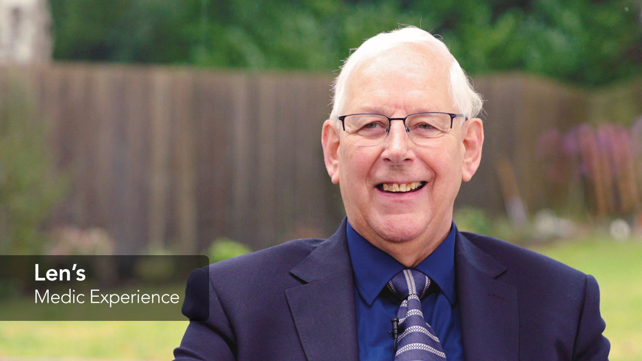 Image of Len outside in his garden smiling at the camera 