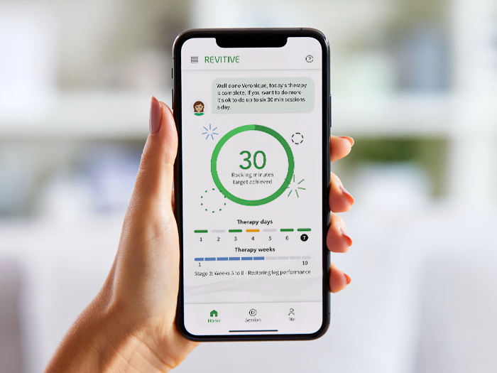Image of a hand holding onto a phone with the app displaying on the screen