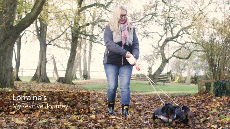 Image of Lorraine walking her dogs through a park
