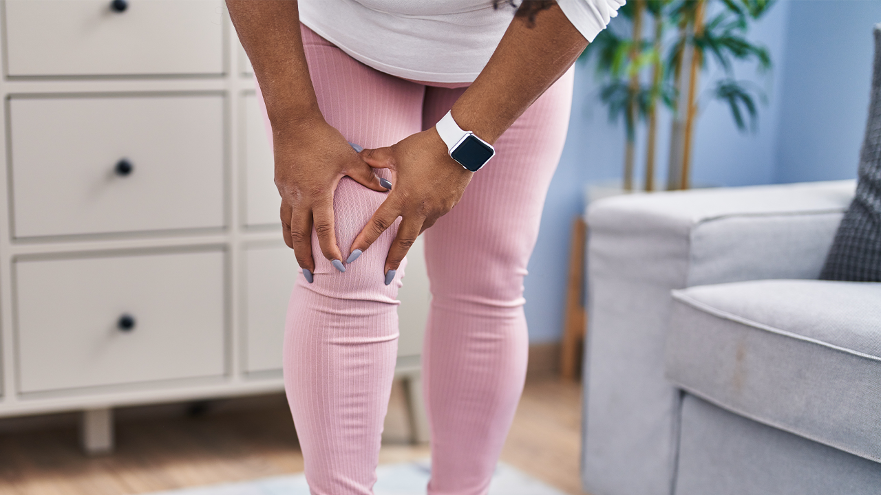 Image of a woman standing while crabbing her knee