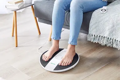 Close up of ladies legs and feet on the prohealth device 