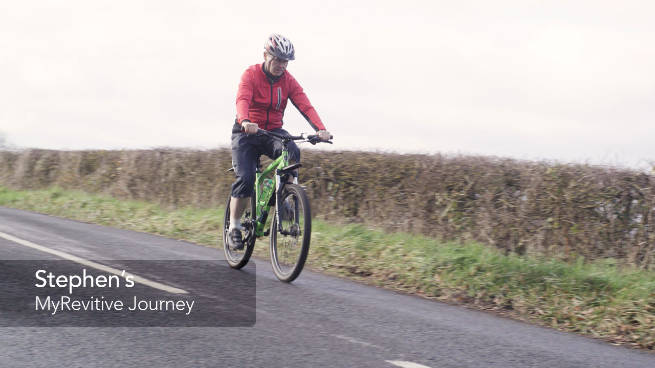 Image of Stephen riding his bike on the road through the country side 