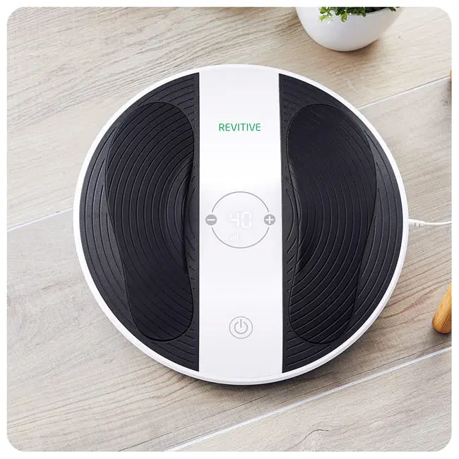 Image of the prohealth device, in a home setting, with wooden flooring bottom on chair and plant