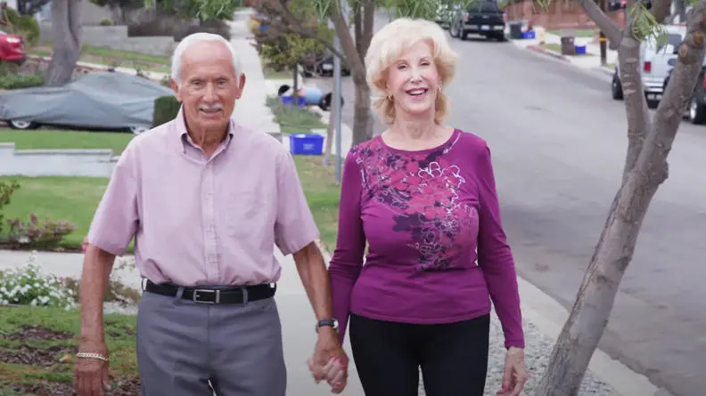 Image of Maureen and Dennis smiling and walking towards the camera